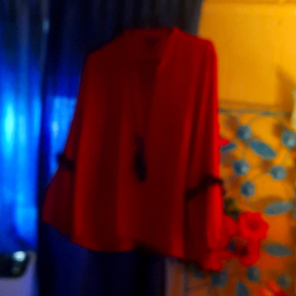 Signature studios red long sleeve blouse with black fringe on sleeve  and  neck.